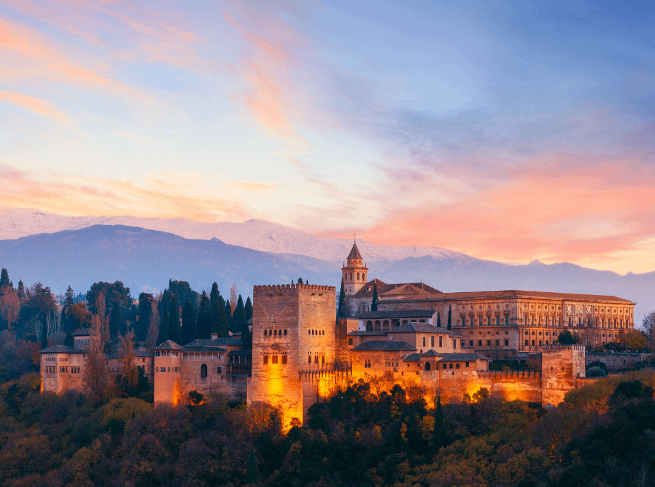 alhambra palace lit up in the evening